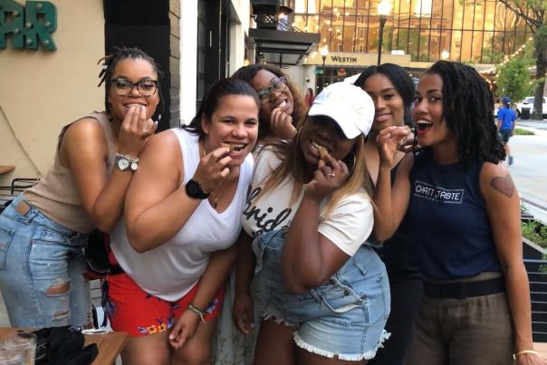 people pose and pretend to take a bite in west village