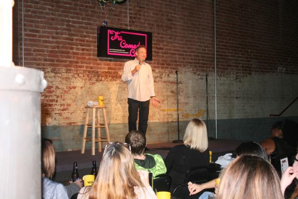 Comedian performs on stage at the Comedy Catch