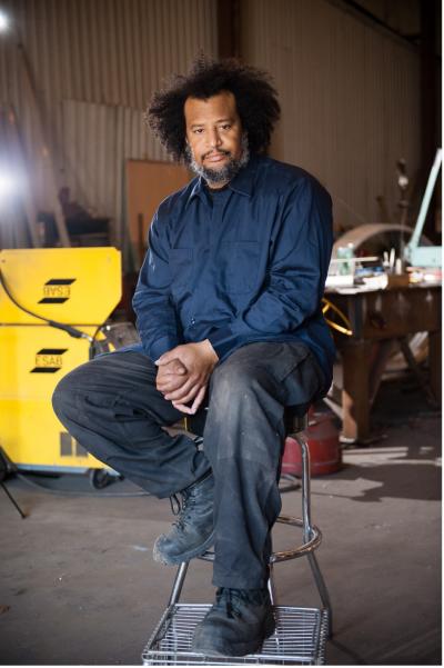 Isaac Duncan poses for photo on a stool | photo credit: Dotson Commerical