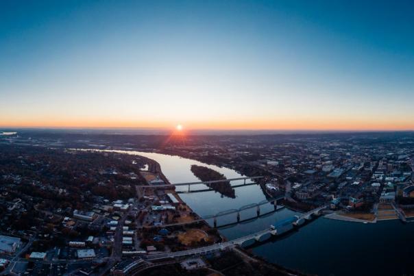 Panoramic aerial shows Chattanooga and river as sun rises over horizon