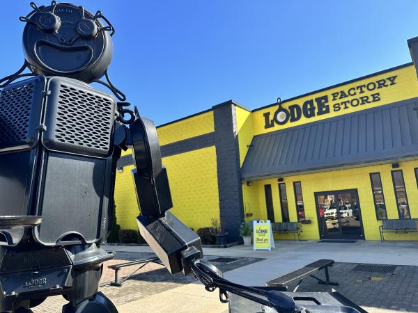 Sculpture Outside of Lodge Museum is pieces of cast iron made to look like a smiling person grilling out