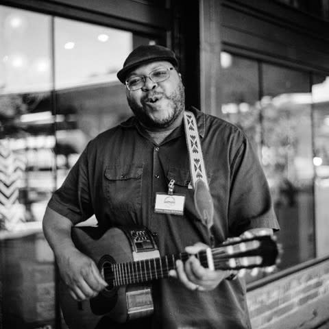 Local artist Tre plays guitar